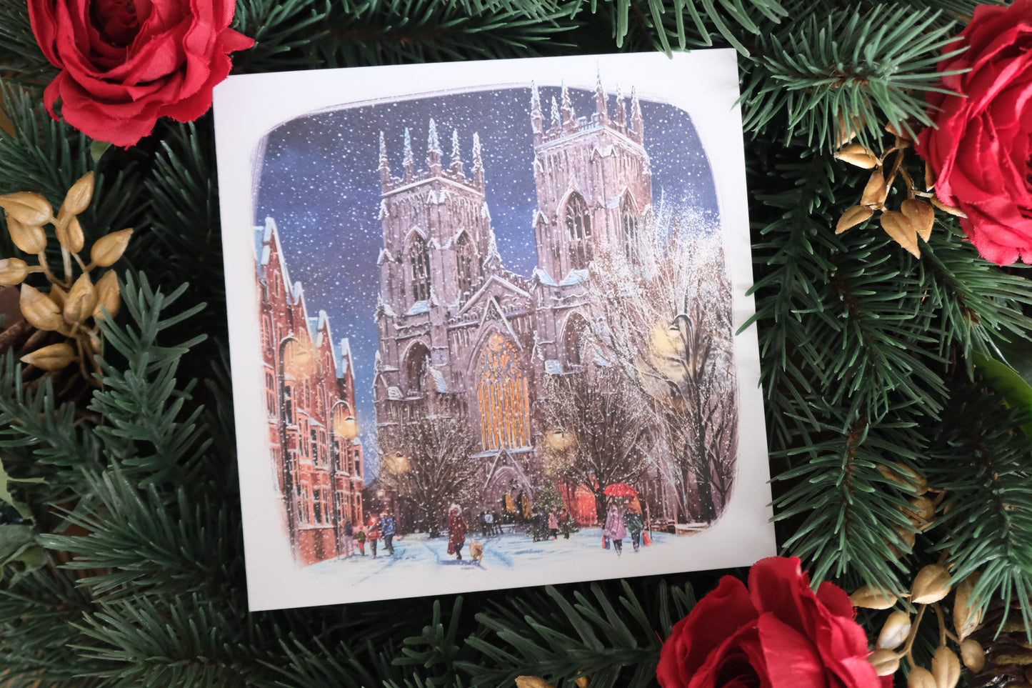 Christmas card with a snowy York Minster illustration surrounded by festive decorations.
