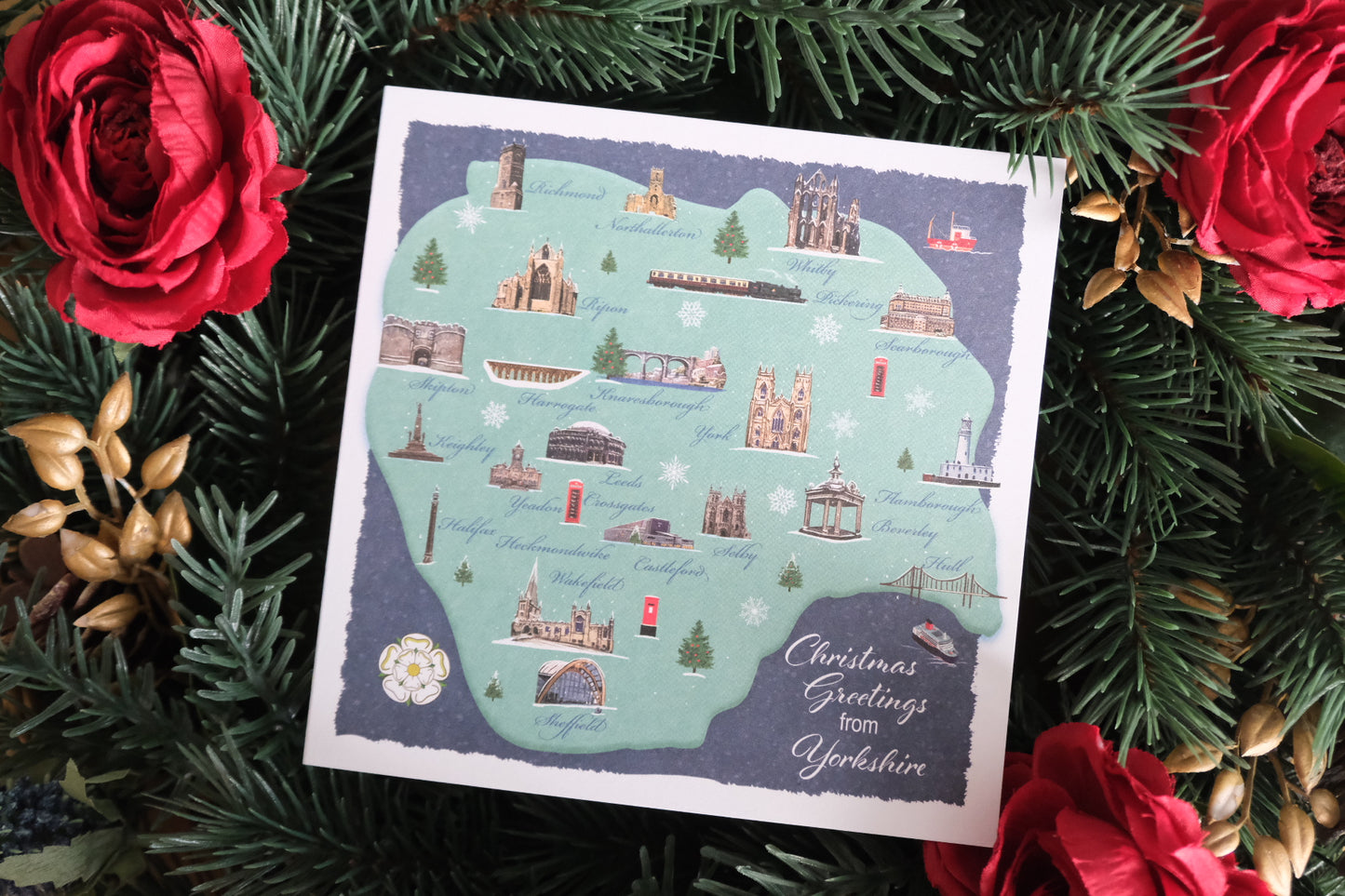 Christmas card showing a map of Yorkshire highlighting some key buildings and sights.