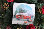Christmas card depecting a classic camper van with a Christmas tree on the roof. 