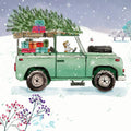Green vintage truck with Christmas tree and gifts in a snowy landscape