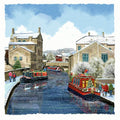 Skipton village with snow-covered buildings and canal boats on a canal.
