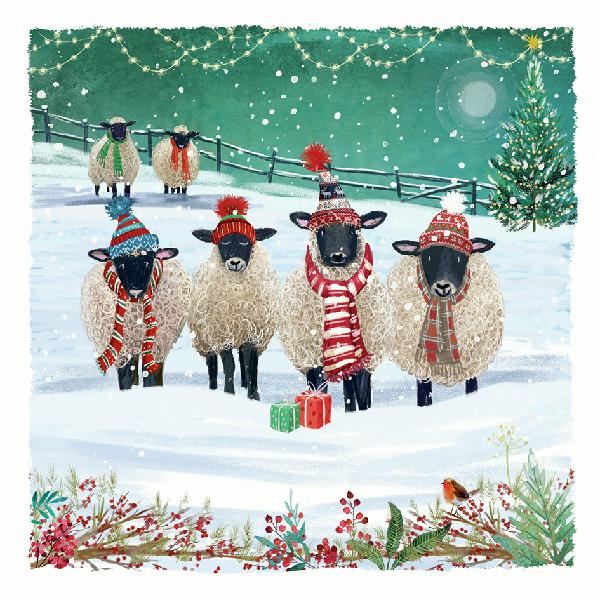 Sheep wearing winter hats and scarves in a snowy scene with Christmas decorations.
